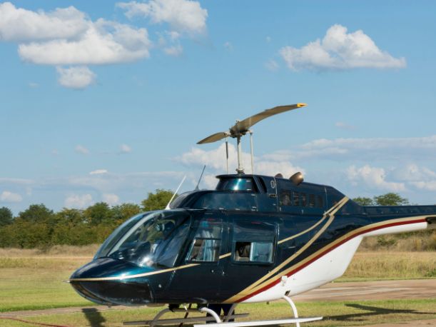 A helicopter on display on a grassy field