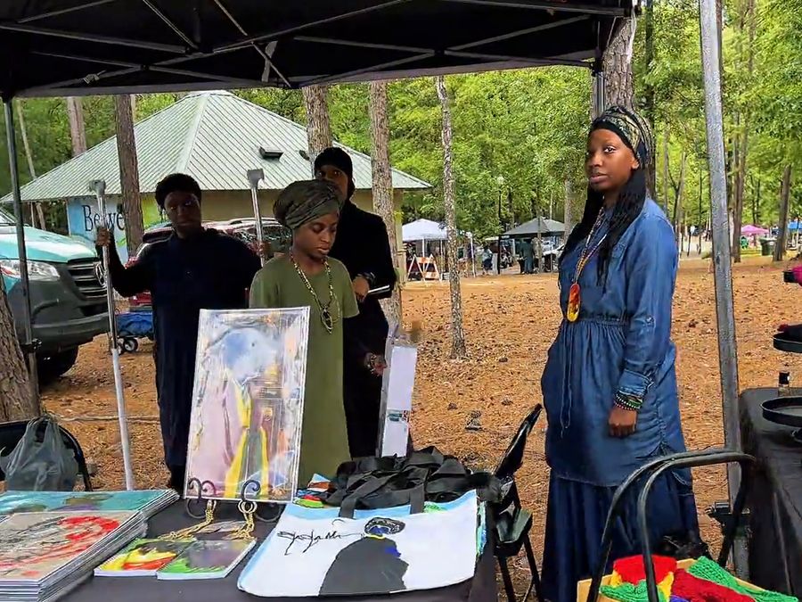 Vendors selling handmade art and crafts at their booth